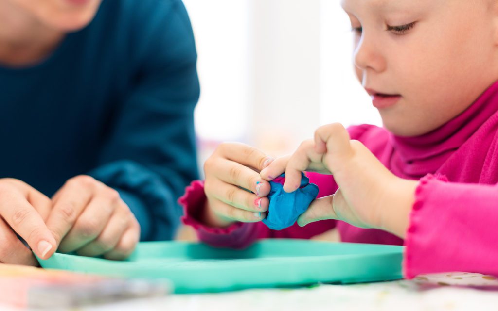 girl playing with clay